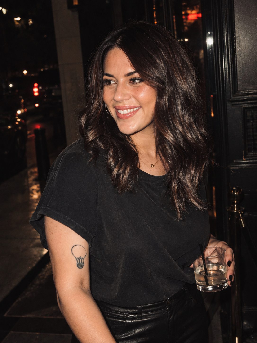 Taylor Slaughter smiling on a city street at night